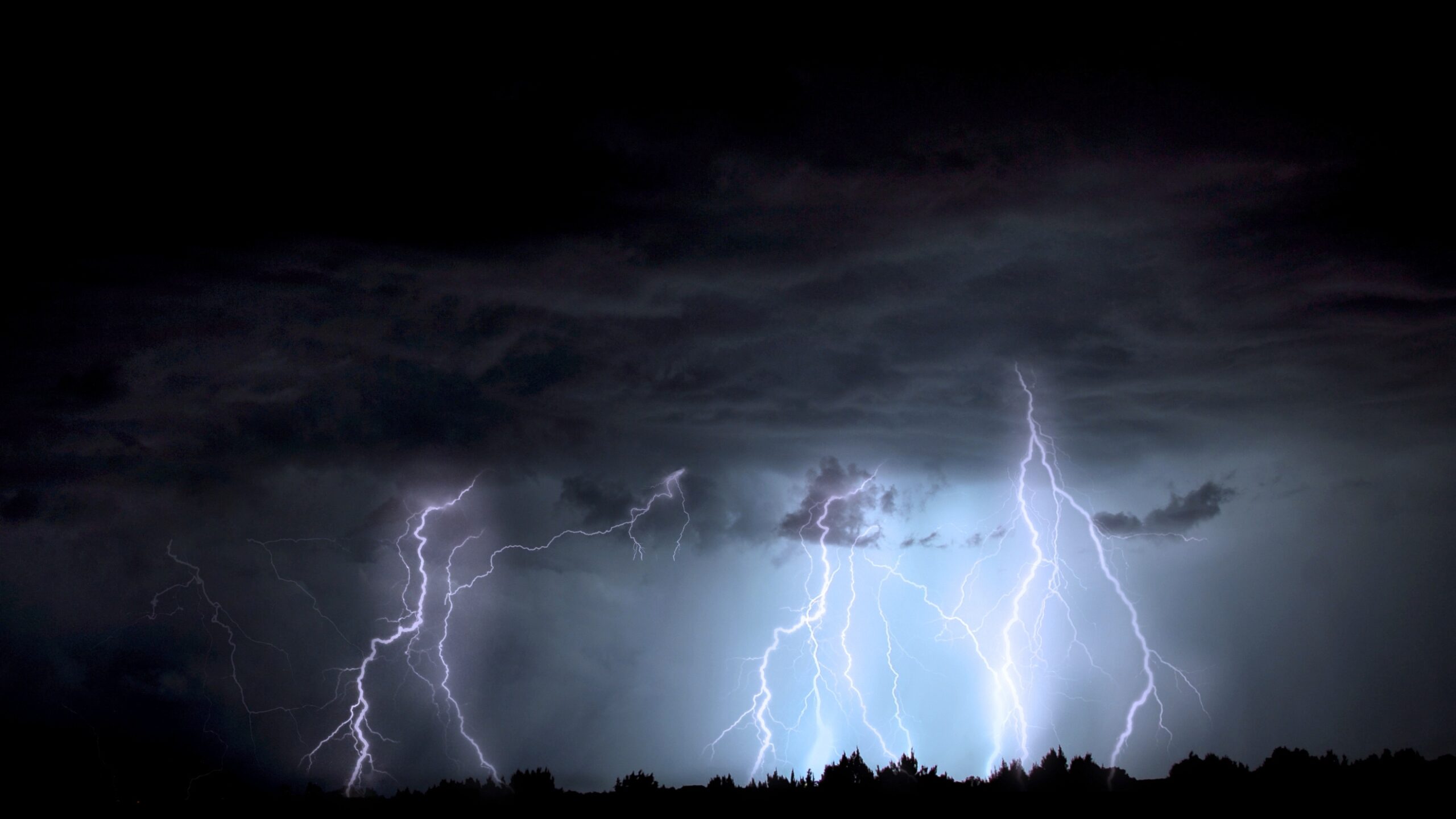 A dark sky with thunder and lightning storms